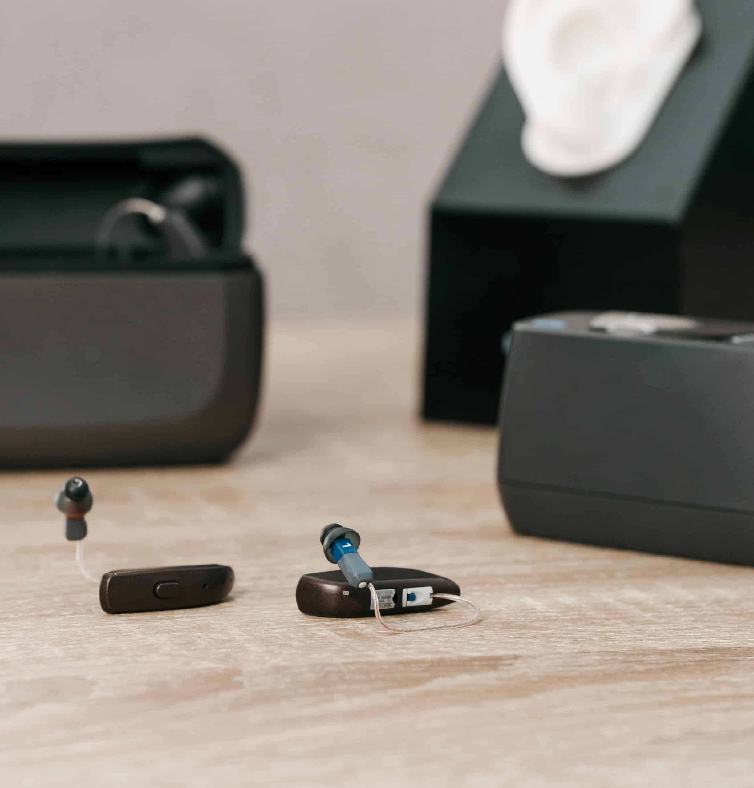 Receiver-in-canal hearing aids with charging cases.