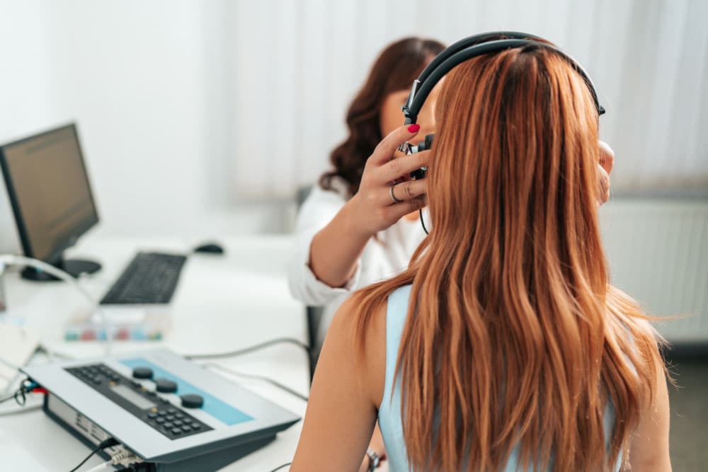Audiologist administering a hearing test.