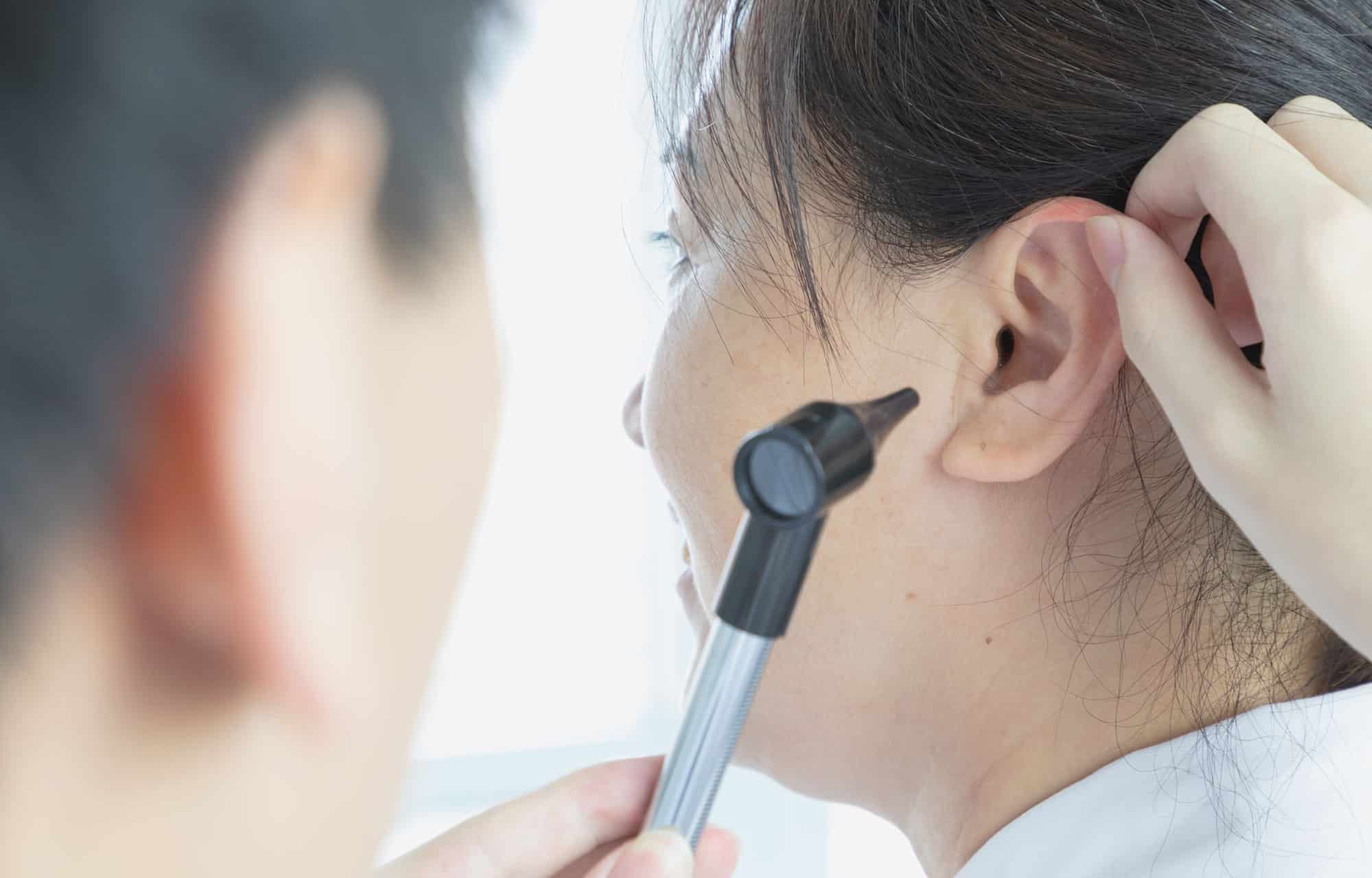Audiologist administering a hearing test.