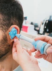 A man, having procedure making customized to his individual ear shape.