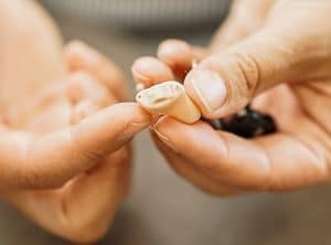 Person holding a hearing aid